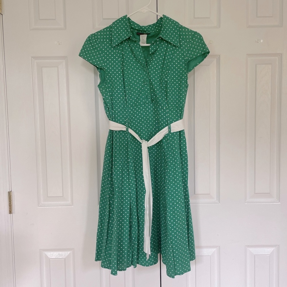 Kelly green with white polka dots dress with a white belt and flare skirt
